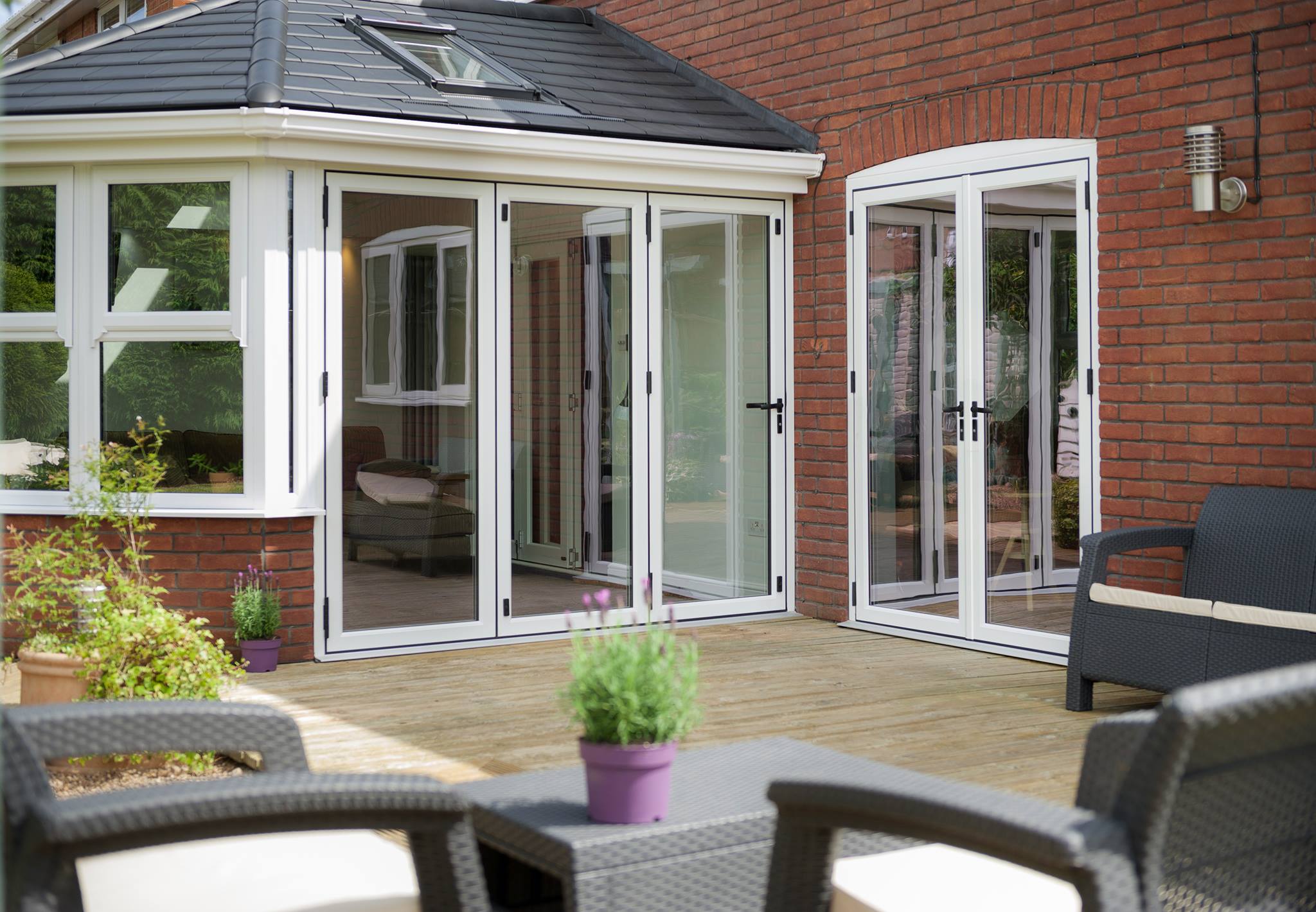 Aluminium bi-folding doors fully open from kitchen to patio